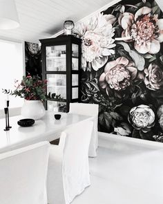 black and white floral wallpaper in a dining room with large flowers on the wall