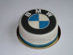 a white and blue cake with the word bmw on it