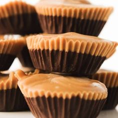 several chocolates with peanut butter on top are stacked up and ready to be eaten