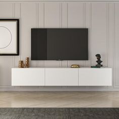 an empty living room with a large flat screen tv on top of a white entertainment center