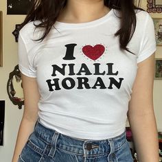 a woman wearing a t - shirt that says i love nail horan on it