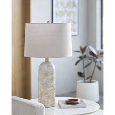 a white table with a lamp on top of it