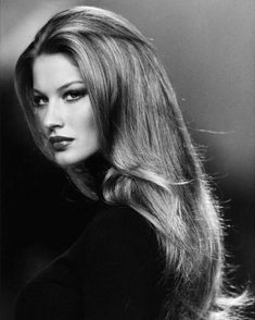 a black and white photo of a woman with long hair