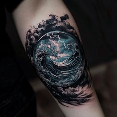 a man's arm with a wave and lightning tattoo on it