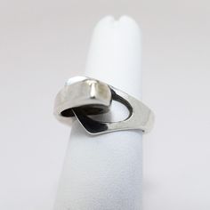 This is a nice Mid Century Modernist ring by Niels Erik From (Denmark). The piece is signed & hallmarked Sterling silver. The ring is in good vintage condition with only light wear consistent with age. The ring measures a US size 6 and weighs .28 Troy ounces. If you have any questions or would like to see additional pictures, please contact us before making your purchase. Buyers outside the United States, please contact us for a shipping estimate. Modernist Open Band Rings For Formal Occasions, Retro Polished Rings For Formal Events, Retro Formal Rings With Polished Finish, Retro Rings With Polished Finish For Formal Occasions, Modernist Polished Finish Ring For Anniversary, Modernist Ring With Polished Finish For Anniversary, Modernist Rings With Polished Finish For Anniversary, Vintage Tension Setting Ring Jewelry, Modern White Gold Collectible Rings