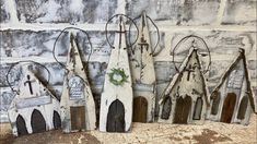 five wooden church pieces with wreaths on them sitting in front of a brick wall