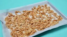 a white tray filled with granola on top of a blue table