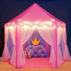 a pink princess tent with fairy lights on it