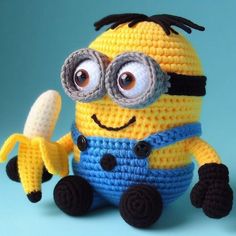 a crocheted minion holding a banana