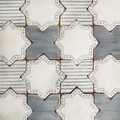 an old tile pattern is shown in grey and white