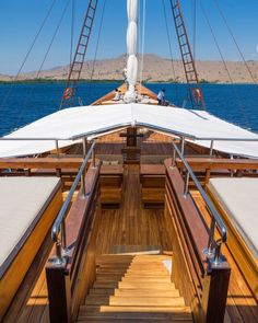 the stairs lead up to the upper deck of a sailboat in the open water