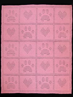 a pink crocheted doily with letters and numbers in the center on a black background