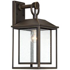 an outdoor wall light with a clear glass shade