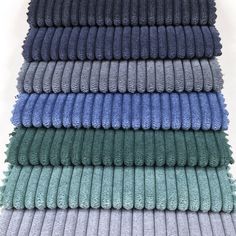 towels stacked on top of each other in different colors