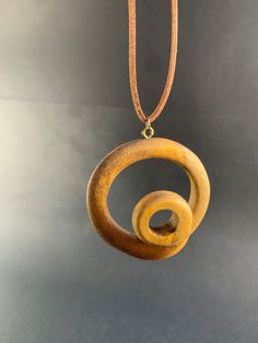 ** Spiral Pendant ** Diameter: 55 mm  Depth : 25mm This unique spiral pendant pine tree wood.  It comes with Korean waxed cord and has lobster clasp at the end. For custom necklace lengths send me a message. If you have any questions about this item or any other items in my shop , message me and I will be more than happy to help. --------------------------------------- HOW LONG CAN YOU PREPARE AND SEND MY PRODUCT? --------------------------------------- This period is 1 to 2 working days at most, depending on the order density. We usually ship your orders on the same day or 1 day later at the latest. Your product is carefully packed and shipped. --------------------------------------- You can give this unique necklace as a gift to your loved ones;  Gifts for Boyfriend Gifts for Dad Gifts f Handmade Round Earthy Necklaces, Handmade Earthy Round Necklaces, Handmade Round Earthy Necklace, Bohemian Handmade Circle Necklace, Handmade Circular Brown Jewelry, Handmade Brown Circular Jewelry, Rustic Handmade Necklaces, Rustic Handmade Round Necklace, Wooden Jewelry Handmade