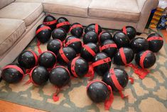 a bunch of black and red balloons on the floor