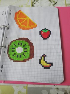 an open notebook with some pixel art on it