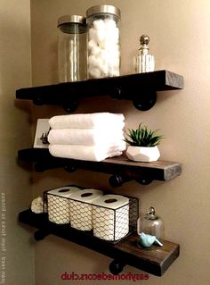 bathroom shelves with towels, soaps and other items on them in a home setting