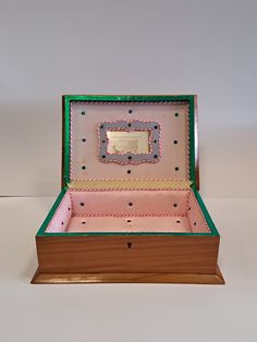 an open pink and green box on a white surface