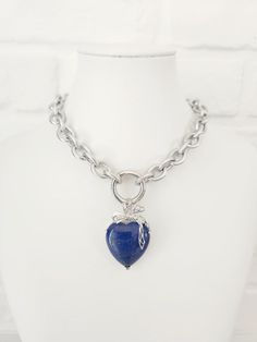 Thick Texturized Chain Stainless Steel Necklace with Lapis Lazuli Heart Pendant This stunning chunky charm necklace is the perfect statement piece. This necklace exudes elegance and style and features a large, beautifully crafted Lapis Lazuli heart pendant. The thick, texturized stainless steel chain adds a modern touch, ensuring durability and a sleek finish. Key Features: Material: High-quality stainless steel chain Pendant: Large Lapis Lazuli heart Design: Chunky, texturized chain with a big Chunky Metal Heart Pendant Necklace, Silver Bohemian Lapis Lazuli Necklaces, Luxury Statement Lapis Lazuli Necklace, Blue Lapis Lazuli Crystal Necklace - Perfect Gift, Artisan Blue Heart-shaped Necklace, Etsy Jewellery, Lapis Lazuli Jewelry, Necklace Chunky, Handmade Fashion Jewelry