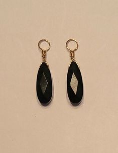 One Pair of faceted Dangling Earring Charms or earring jackets featuring 6x16mm AA Genuine Black Onyx drops.    ALL EARRING WIRES ARE SOLD SEPARATELY.  CHANGE THE WIRES or ADD STUDS AND YOU CHANGE THE LOOK. The photos don't show it, but these are faceted stones. These are hand crafted in your choice of Solid Sterling Silver, 14K Rose or Yellow Gold filled wire. They have 4.0mm openings to fit over your favorite hoops, studs or interchangeable lever back wires available in our store. This pair measures approximately 1 inch long not including any studs, hoops or wires that are sold separately. Looking for a certain color? Just ask!!  All measurements are as close as possible within the limitations and restrictions imposed by the mounting. Artisan Jewelry Earrings, Amber Bead Necklace, Interchangeable Earrings, Earring Wires, Earring Jackets, Earring Charms, Handcrafted Artisan Jewelry, Turquoise Gemstone, Charm Earrings