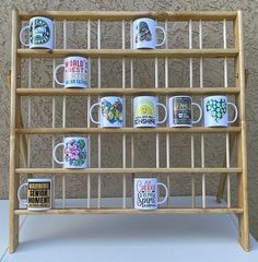 a wooden shelf with coffee mugs on it