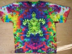 a colorful tie - dyed t - shirt on a wooden surface