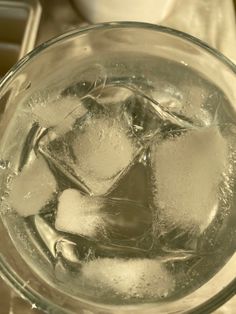 ice cubes in a glass on top of a table