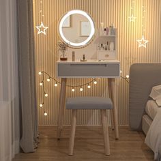 a bedroom with a vanity, mirror and lights on the wall next to a bed