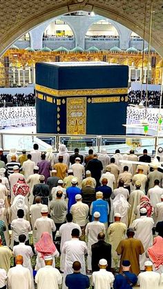 a large group of people standing in front of a blue and gold kabab