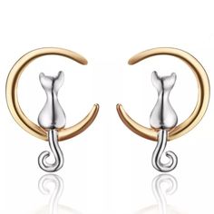 two tone gold and silver cat earring with crescent design on the front, set against a white background