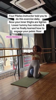 a woman sitting on top of a yoga mat in front of a window with a quote above her