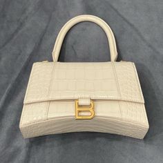 Balenciaga Hourglass Bag. Color Beige/ White. New, Only Used Once. In Excellent Condition. 100% Authentic. No Scratches Or Damages. Comes With Dust Bag And Strap. Offers Accepted Balenciaga Giant City Bag, Balenciaga Hourglass Bag, Balenciaga Neo Classic, Bags Balenciaga, White Balenciaga, Balenciaga Leather, Balenciaga Handbags, Classic Handbags, Brown Handbag