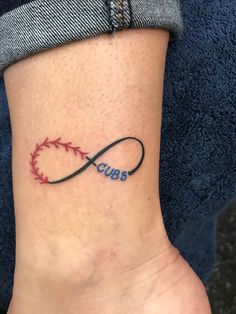 a woman's foot with a tattoo on it that says cubs in the shape of a baseball