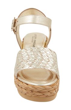 Mixed textures lend visual intrigue to an espadrille-inspired sandal lifted by a raffia-wrapped platform and integrated wedge heel. 2 3/4" heel; 1 1/4" platform Adjustable ankle strap with buckle closure Cushioned footbed Leather and textile upper/leather lining/synthetic sole Made in Spain Gold Straw Sandals With Round Toe, Gold Open Toe Espadrilles With Removable Insole, Gold Espadrilles With Woven Sole For Vacation, Gold Sandals With Woven Sole And Ankle Strap, Chic Gold Open Toe Espadrilles, Gold Ankle Strap Sandals With Woven Sole, Gold Platform Espadrilles With Round Toe, Gold Wedge Heel Sandals With Woven Sole, Gold Espadrilles With Woven Sole