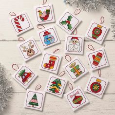 cross stitch christmas ornament kits on white wooden background