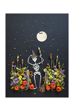 the skeleton is surrounded by flowers and candles