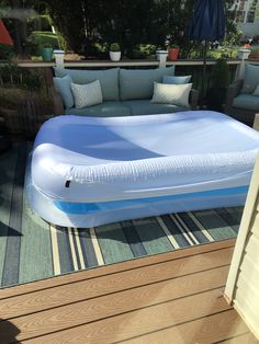 an inflatable mattress sitting on top of a wooden deck