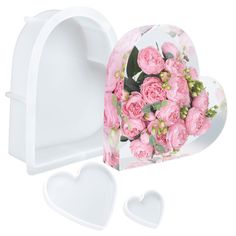 a heart shaped box with pink flowers inside