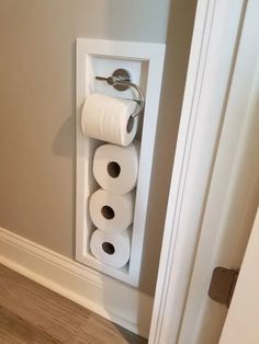 two rolls of toilet paper are hanging on the wall