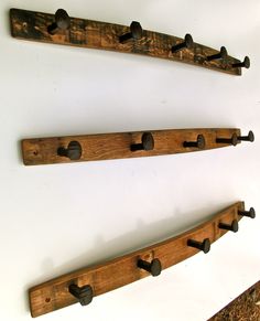 three wooden pegs are hanging on the wall