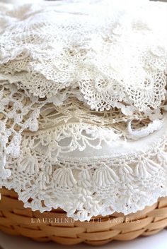 a basket filled with white lace sitting on top of a table