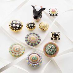 an assortment of decorative knobs on a white surface