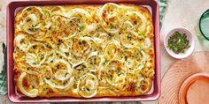 a casserole dish with onions and herbs