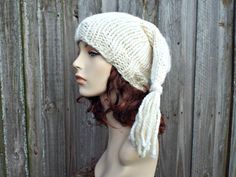 a mannequin head wearing a white knitted hat