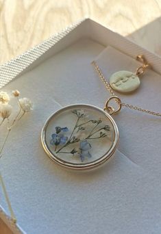 A beautiful and unique Botanical inspired terrarium necklace with real forget me not flowers and baby breath flowers (gypsophila) For memories of a close one, for true love and to show someone you will never forget them 💕The flower is encapsulated in a crystal clear Resin which is Non-toxic, No VOCs, No fumes, No solvents, Non-flammable, Non-hazardous, No BPA. The necklace chain is gold plated solid brass or stamped 14k gold filled chain as shown in last photo. This chain is much more long last Dainty Flower Pendant Jewelry For Keepsake, Dainty Flower Pendant Jewelry Keepsake, Dainty Birth Flower Jewelry For Keepsake, Delicate Mother's Day Keepsake Necklace, Delicate Birth Flower Jewelry For Keepsake, Pressed Flowers Keepsake Jewelry, Delicate Charm Necklace With Pressed Flowers For Gifting, Delicate Pressed Flowers Charm Necklace Gift, Delicate Charm Necklace With Pressed Flowers For Gift