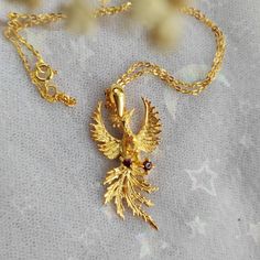 Phoenix Fire Bird Sterling Silver Necklace with Real Citrine and Garnet with 22k gold plated. Phoenix (/ˈfiːnɪks/; Ancient Greek: φοῖνιξ, phoînix) is a mystical bird associated with fire and sun, it obtains new life by arising from the ashes of its predecessor. Original design from sketch of Phoenix Pendant with citrine faceted teardrop and garnet faceted round. Material: full sterling silver 925. pendant size: 4x2cm Chain length: 40cm Please bear in mind that photo may slightly different from a Phoenix Fire Bird, Phoenix Fire, Fire Jewelry, Phoenix Necklace, Phoenix Pendant, Fire Bird, Book Jewelry, Fancy Jewelry, Disney Outfits