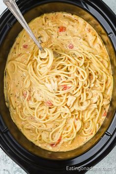 an image of pasta in the crock pot with a ladle on the side