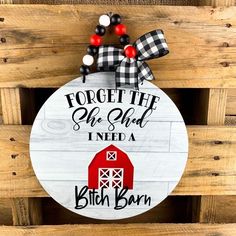 a sign that says forget the lord, i need a red barn with a black and white checkered bow