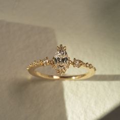 a yellow gold engagement ring with diamonds on it